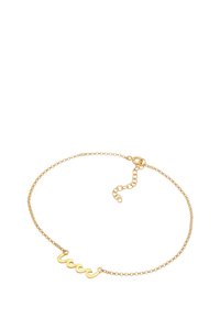 Pulsera de cadena de oro delicada con un centro con barra ondulada y cierre ajustable sobre un fondo blanco.