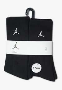 Calzini neri da uomo in confezione da sei, realizzati in tessuto strutturato, con un piccolo logo Jumpman bianco. Tenuti insieme da una fascia bianca.