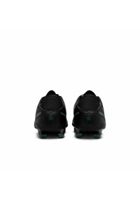 Black soccer cleats with a streamlined design, textured upper, and green accents; features rear stabilizer and molded studs for traction.