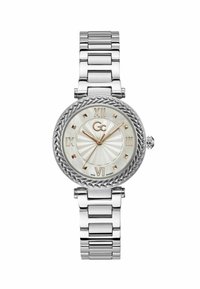 Orologio in metallo argento con cassa ovale, quadrante in madreperla, dettagli in oro e una ghiera intrecciata. Presenta numeri romani e un bracciale a maglie.