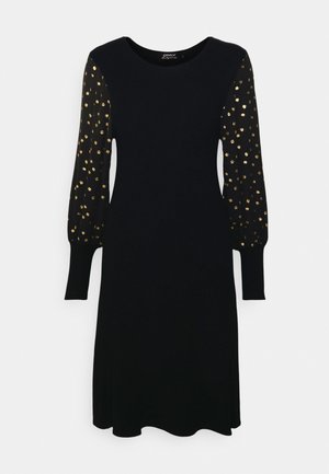 Must mustrõiv mustade pikkade puffvarrukatega, millel on kuldse täpikujundusega. Ümar kaelus, pehme kangas, A-lijniline siluett ja mansetiga varrukad.