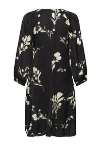 Robe noire avec un motif floral en crème. Manches longues avec un détail froncé et une silhouette décontractée. Tissu doux avec un léger éclat.