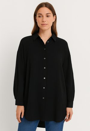 Black button-up shirt made of textured fabric, featuring a collar, long sleeves, and a rounded hem. Front buttons are silver-toned.