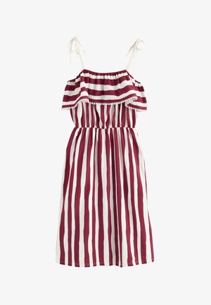 Vestido sin mangas con rayas verticales rojas y blancas, parte superior con volantes y rayas horizontales, y tirantes blancos que se anudan en los hombros.
