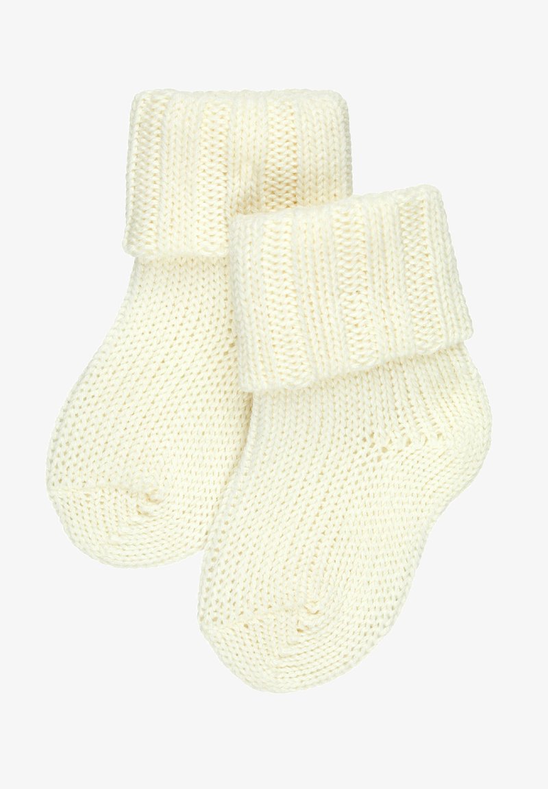 Skarpetki w kolorze kremowym, wykonane na drutach, z prążkowanym mankietem, z teksturowanym wzorem i zaokrąglonym czubkiem.