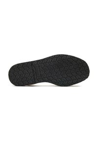 Black rubber shoe sole with a textured pattern featuring grooves and ridges for traction. Lightweight design with a flat profile.