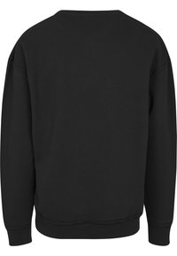 Sweatshirt noir à manches longues avec col rond, poignets et taille côtelés, montré de dos sur un fond blanc.