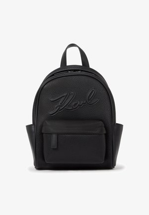Black leather backpack with a textured finish, featuring a prominent curved top, front pocket, and embossed logo detail.