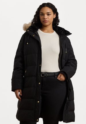 Black puffer coat with a faux fur-lined hood, featuring a zip closure, side pockets, and gold-tone hardware. Worn over a light sweater.