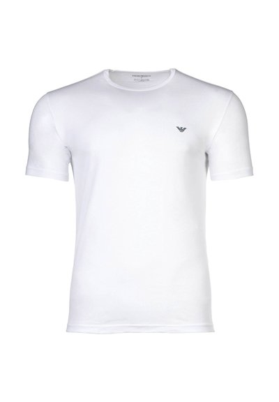 T-shirt blanc à manches courtes et col rond avec petit logo noir de l'aigle Armani sur la poitrine gauche, présenté sur un fond uni.