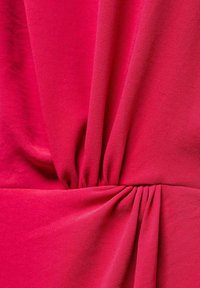 Fuchsiová látka s jemnou textúrou, s drapovanými záhybmi a skladaným akcentom v páse, znázorňujúca hladké, plynulé dizajnové prvky.