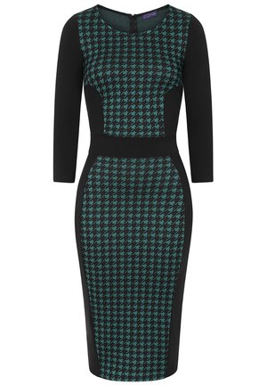 Haljina s uzorkom poznatim kao houndstooth u crnoj i tirkiznoj boji, priljubljenog kroja, s rukavima do tri četvrtine i okruglim izrezom. Zatvaranje na zatvarač na leđima.