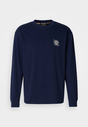 Maglietta a maniche lunghe blu navy in cotone, con un piccolo disegno di sole ricamato sul petto e polsini a costine.