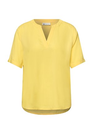 Blouse jaune à manches courtes avec revers roulés et fente en V, dotée d'un ourlet arrondi et d'une étiquette "Street One" à l'intérieur du col.
