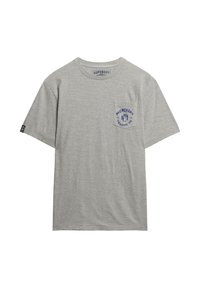 Camiseta de algodón gris con cuello redondo, mangas cortas y un bolsillo en el pecho izquierdo que presenta un logotipo impreso en azul. Corte relajado y textura suave.