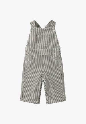 Salopette rayée noire et blanche pour tout-petit avec poche avant, deux poches latérales et bretelles boutonnées sur fond blanc.