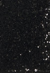 Černá l�átka pokrytá hustými flitry, vytvářející texturovaný povrch s reflexními prvky, které zachytávají světlo. Rovnoměrné uspořádání flitrů.