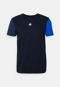 Navy blue cotton T-shirt with short sleeves; features a contrasting blue sleeve and a small white logo on the chest.