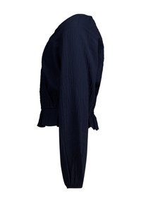 Navy blue cropped jacket, features textured fabric, round neckline, billowing sleeves, and a ruffled hem for added detail.