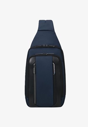Borsa a tracolla blu navy con un mix di materiali tessili e sintetici, dotata di due scomparti con zip e un design slanciato e compatto.