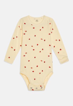 Garais piedurkņu bērnu bodijs mīkstā dzeltenā kokvilnā ar sarkanām pūcias tīklām. Aprīkots ar spiedpogām apakšā, kas nodrošina vieglu pārģēršanos.