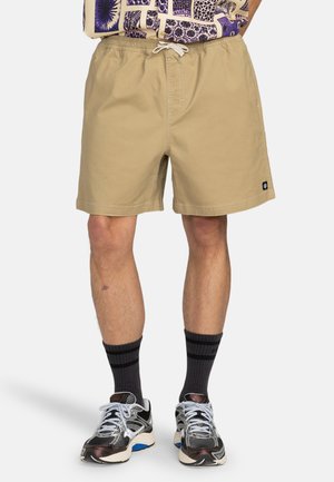 Lichtbeige zwemboxers met een elastische tailleband en een trekkoord. Voorzien van zakken en een klein logo op het linkerbeen. Gestructureerde stof.