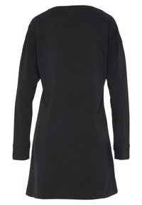 Svart långärmad tunika med rund hals, lös passform och lätt rundad nederkant. Tillverkad av mjukt bomullstyg. Inga synliga mönster eller dekorationer.