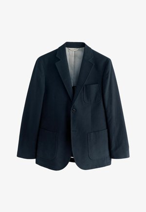 Tengerészeti gyapjú zakó, élénk hajtókával, egysoros gombolással és két nagy elülső zsebbel. Simább bélés és minimális díszítés.