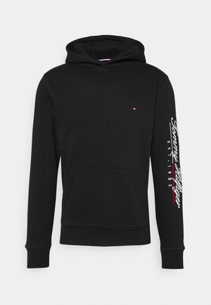 Czarna bluza z kapturem z kieszenią z przodu, małym logo na piersi i napisem "Tommy Hilfiger EST. 1985" na prawym rękawie w bieli i czerwieni.
