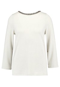 Haut crème clair à manches longues avec un col rond orné de perles argentées. Texture douce et coupe décontractée, avec des détails de couture visibles.