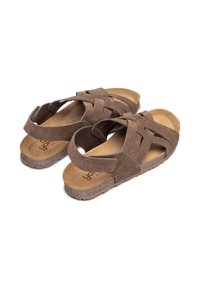 Sandali in suede marrone con cinturini incrociati, punta aperta, soletta imbottita e suola in gomma. Presenta cinturini di chiusura per una vestibilità sicura.