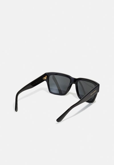 Black sunglasses with a rectangular frame, dark lenses, and gold accents on the arms. Made of plastic with a glossy finish.