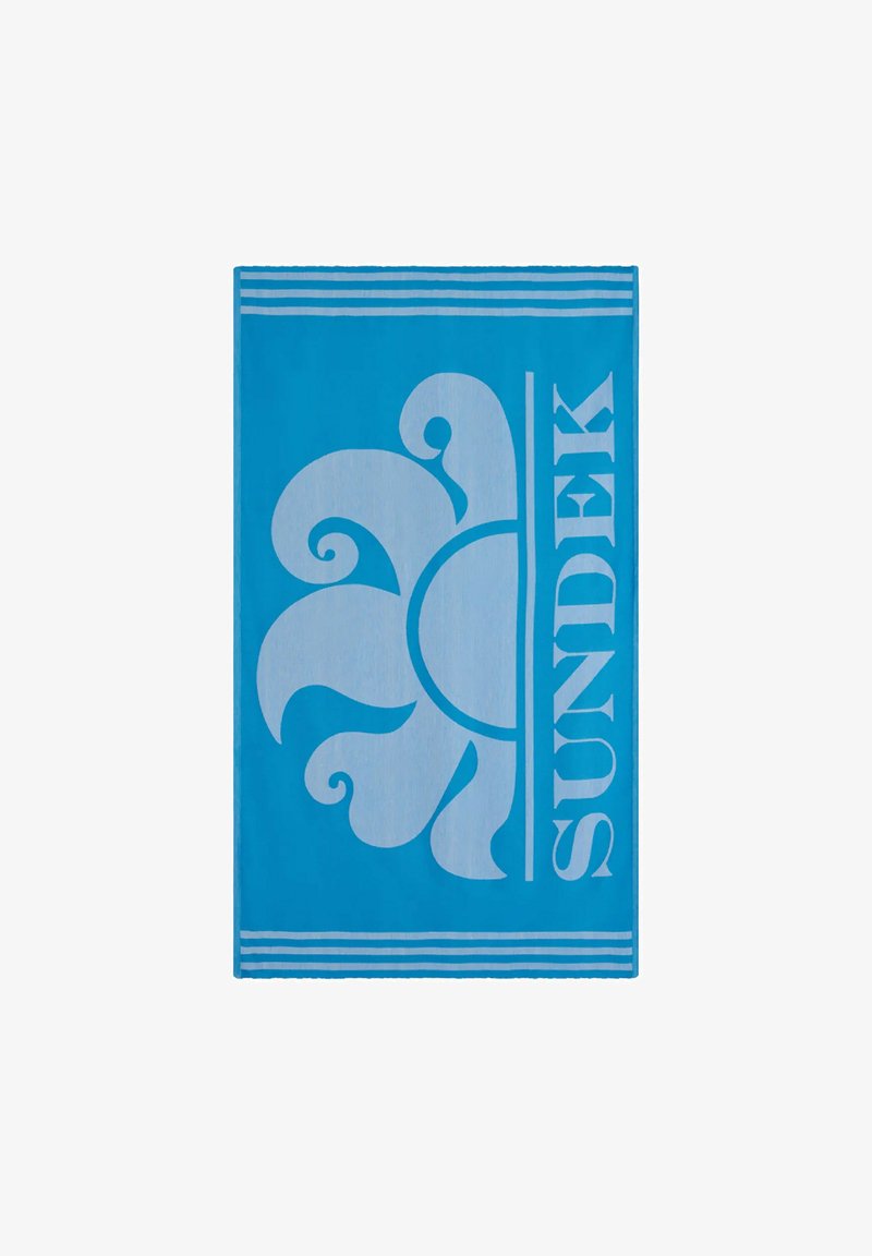 Asciugamano da spiaggia blu con un grande design floreale bianco e il nome del marchio "SUNDEK" in lettering audace, con strisce decorative nella parte superiore.