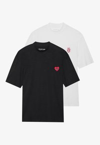 Two T-shirts: one black, one white. Both feature crew necks. Black shirt has a red heart and eye embroidery; white shirt has a small heart graphic.