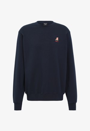 Navy blue crewneck sweatshirt with long sleeves, ribbed cuffs and hem, featuring a small red and white striped emblem on the left chest.