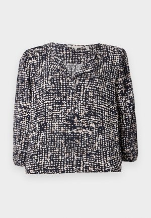 Marinebluse med et strukturert, prikkete mønster i krem og beige, med V-hals og lange puffermer. Laget av lett stoff.