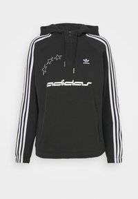 Black hoodie with a drawstring hood, white stripe accents on sleeves, large white "adidas" logo, and star design on front. Soft fabric.