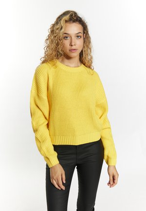 Geel gebreid sweater met lange, losse mouwen en een ribbelzoom. Draag het met zwarte strakke broek. Zachte textuur en lichtgewicht ontwerp.