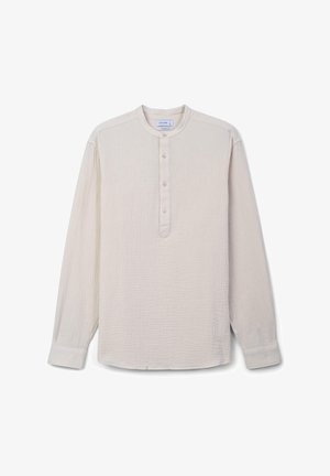 Light beige long-sleeve shirt made of textured fabric. Features a rounded collar and a button placket with five buttons along the front.