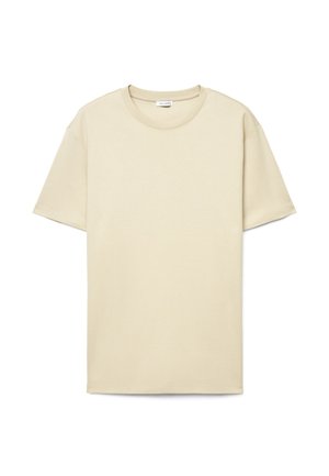 T-shirt beige a maniche corte con scollo rotondo e vestibilità morbida, distesa su uno sfondo bianco.