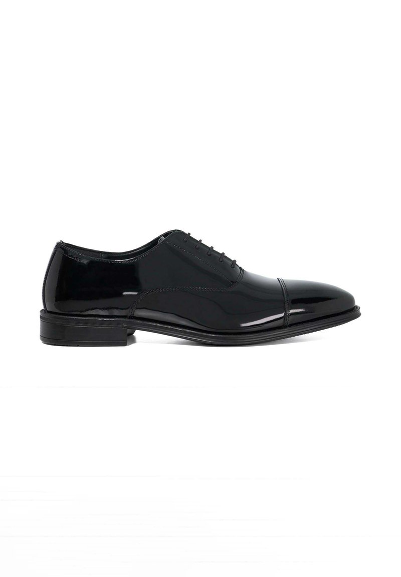 Black patent leather dress shoe with a rounded toe, closed lacing, and a low stacked heel. Features subtle stitching and a glossy finish.