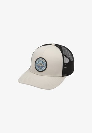 Casquette beige avec un dos en mesh noir, visière plate et un patch rond bleu présentant un design de montagne. La texture du tissu est lisse et durable.