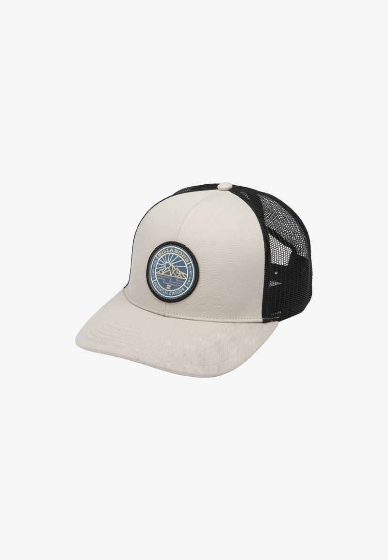 Beige cap with black mesh back, flat brim, and a round blue patch featuring a mountain design. Fabric texture is smooth and durable.
