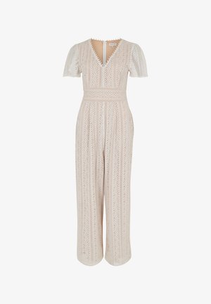 Beige Spitze Jumpsuit mit kurzen Puffärmeln, V-Ausschnitt und tailliertem Design. Hat ein gestreiftes Muster und einen Reißverschluss hinten.