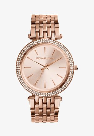 Montre-bracelet Michael Kors en or rose avec un bracelet à maillons, cadran minimaliste sans chiffres et lunette ornée de cristaux.