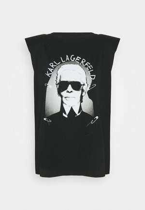 Camiseta sin mangas negra con un gráfico blanco de un hombre que lleva gafas de sol oscuras y texto "KARL LAGERFELD" encima de la imagen.