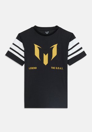 Čierne tričko s krátkym rukávom s bielymi pruhmi na rukávoch, zlaté logo v strede a text "LEGEND" a "THE G.O.A.T." pod logom.
