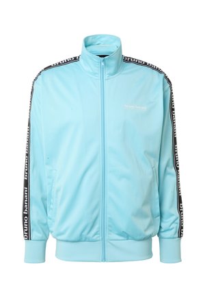 Giacca da track in azzurro chiaro con zip, collo alto, strisce laterali nere con testo "bruno banani" e due tasche frontali.