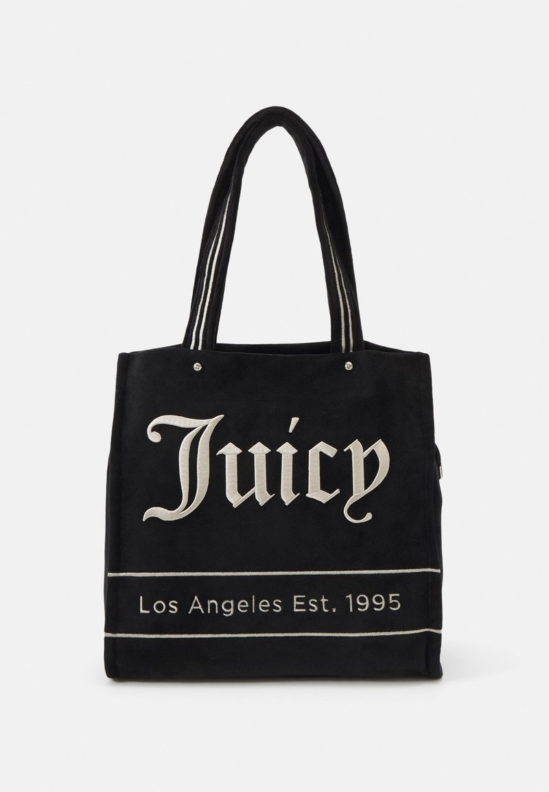 Sac cabas noir avec texte blanc brodé "Juicy" et "Los Angeles Est. 1995" et anses noires à rayures blanches.