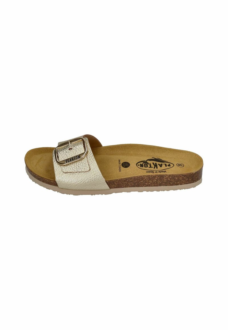 Light beige slide sandal featuring a textured strap with a metallic buckle, cork midsole, and rubber outsole. Soft footbed for comfort.